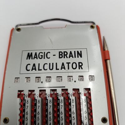 Vintage Magic Brain Calculator with pen stick ( clips broken )