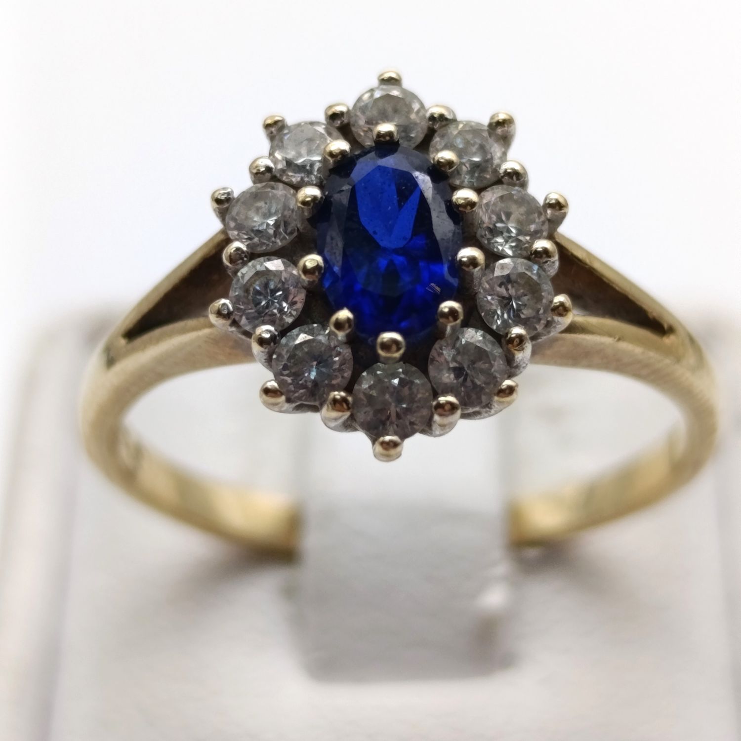 9kt yellow gold ring with dark blue topaz and clear stone accents