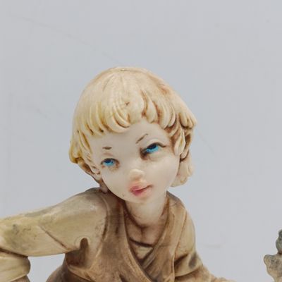 Vintage Simonelli resin sculpture of boy holding grapes
