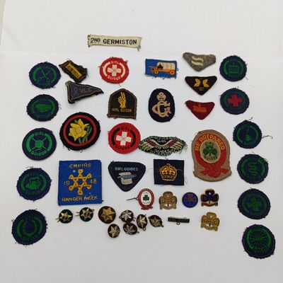 Large lot of vintage Girl Guides cloth and metal badges
