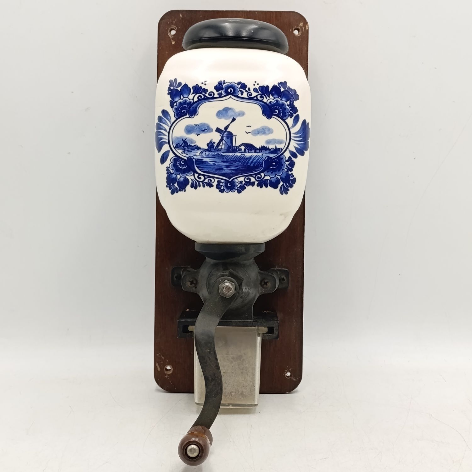 Vintage porcelain coffee grinder on wooden plaque