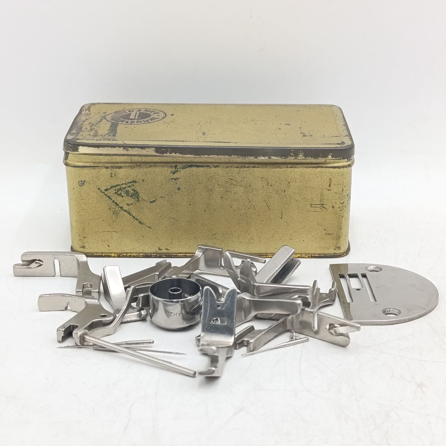 Box with needlework machine parts &amp; shoes