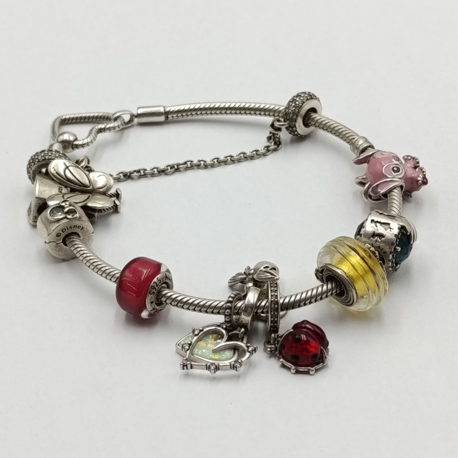 Original Pandora Sterling silver charm bracelet with 9 charms and safety chain - total weight 44.1 grams - length 21cm