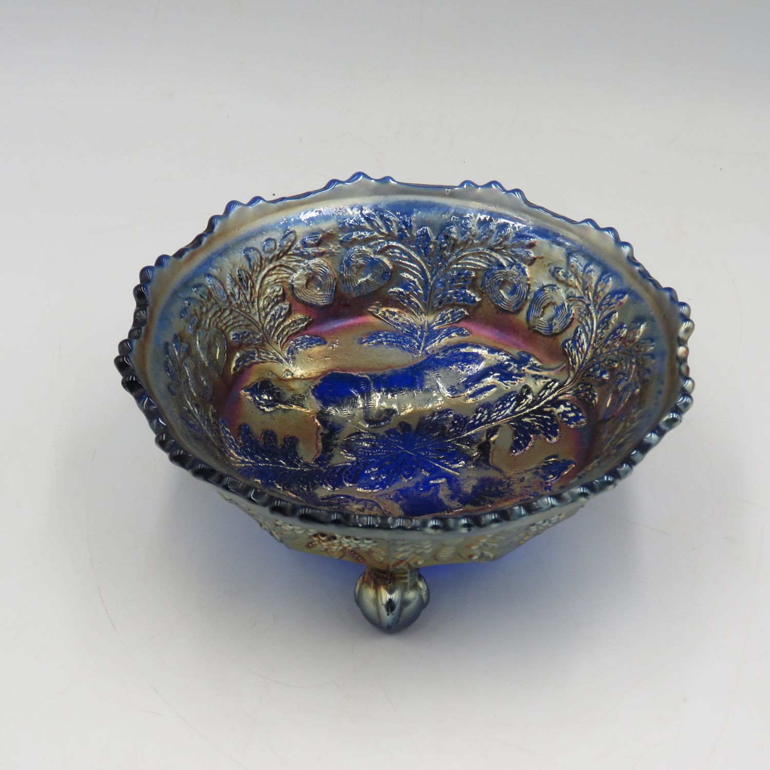 Vintage Carnival glass embossed blue three-legged bowl