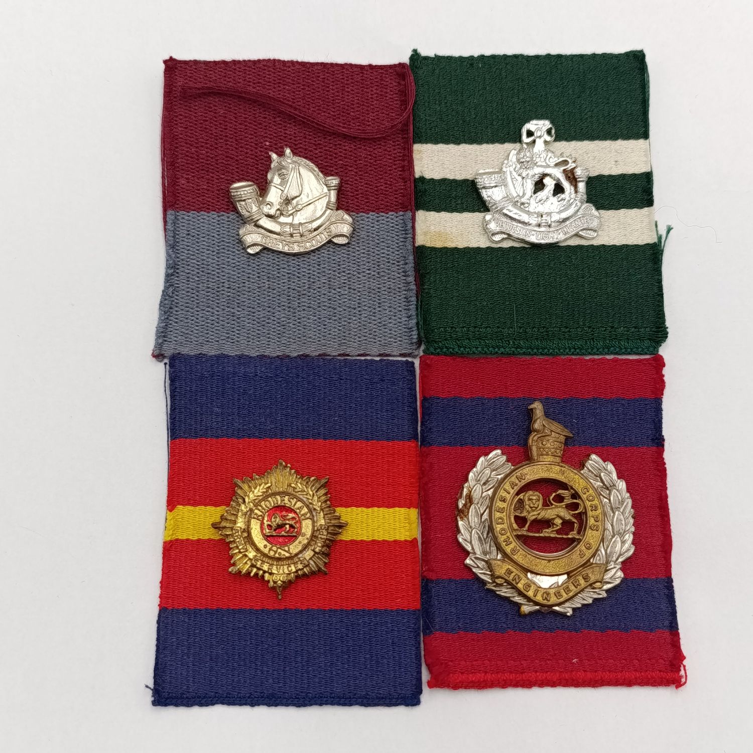 Lot of 4 Rhodesian badges on material backing - possibly from Reuteler set