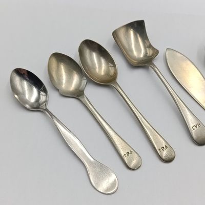 Set of spoons depicting the history of Transvaal Provincial Administration hospitals catering department - 6 metal and 3 plastic types - ons sugar spoon with wrongspelling of TPA (Pat)