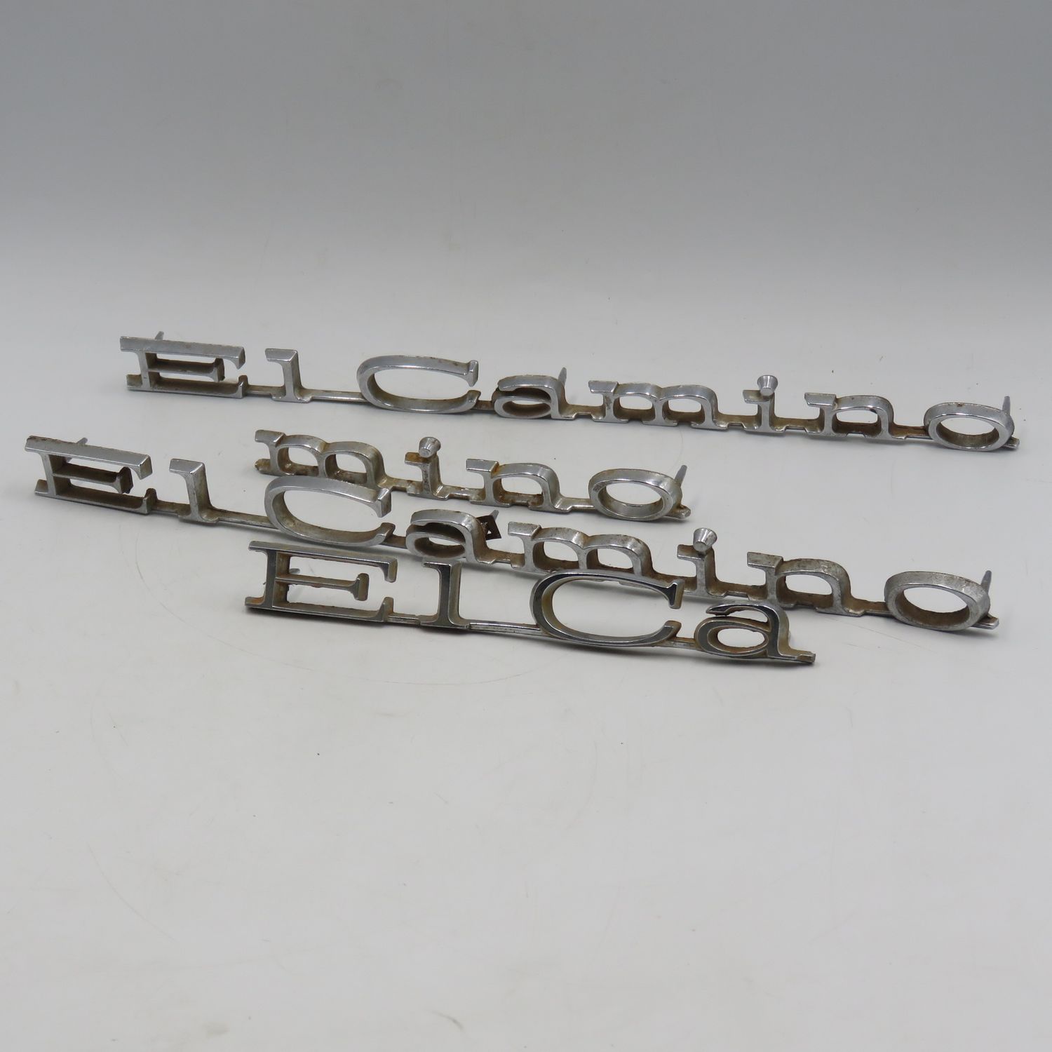 Pair of vintage Chevy El Camino car badges plus an extra broken one