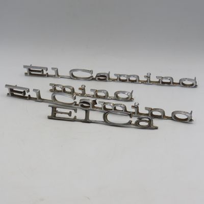 Pair of vintage Chevy El Camino car badges plus an extra broken one