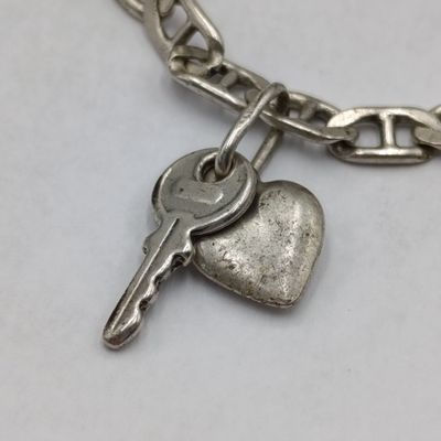 Sterling silver bracelet with 2 charm pendants - weighs 6 grams