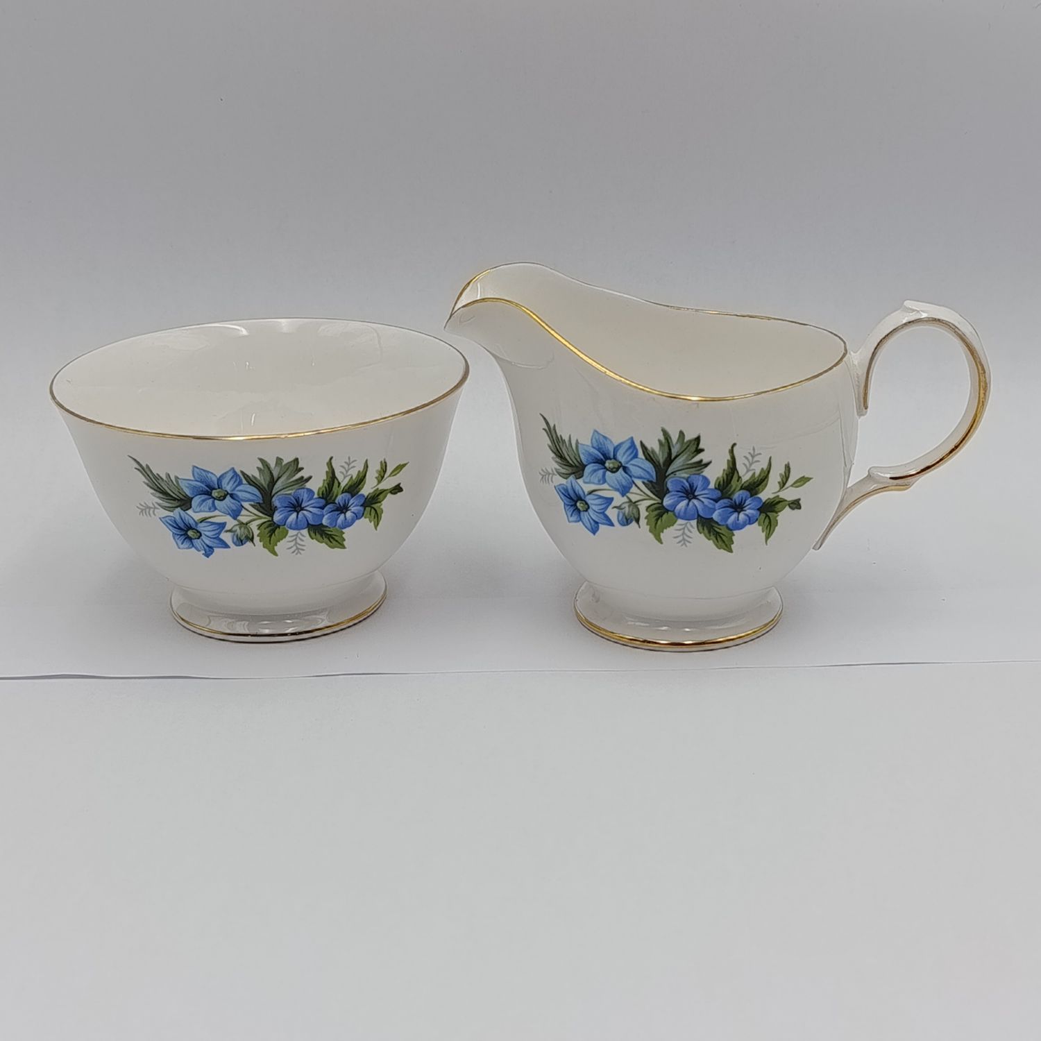 Queen Anne floral design porcelain milk jug and sugar bowl