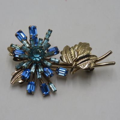 Starburst Flower brooch with aqua and blue rhinestones manufactured by Norman Hartnell - dressmaker to Queen Elizabeth II and the Queen Mother