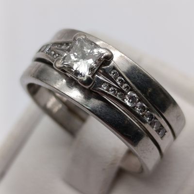 18kt white gold ring with princess cut diamond of about 40 points and 22 smaller diamonds - size P
