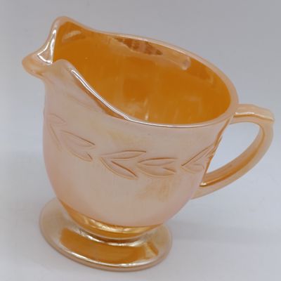 Anchor Hocking Fire-King Peach Lusterware "Laurel Leaf" cream pitcher - footed - 1952-1963