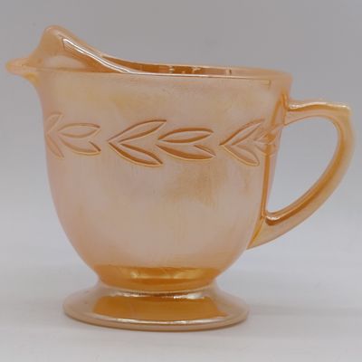 Anchor Hocking Fire-King Peach Lusterware "Laurel Leaf" cream pitcher - footed - 1952-1963