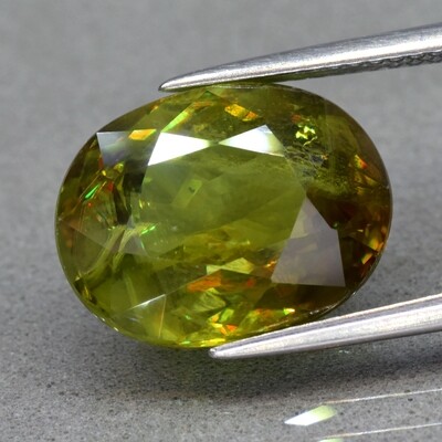 8.37ct 13.6x10.6mm Oval Natural Yellowish Green Sphene, Amazing Luster