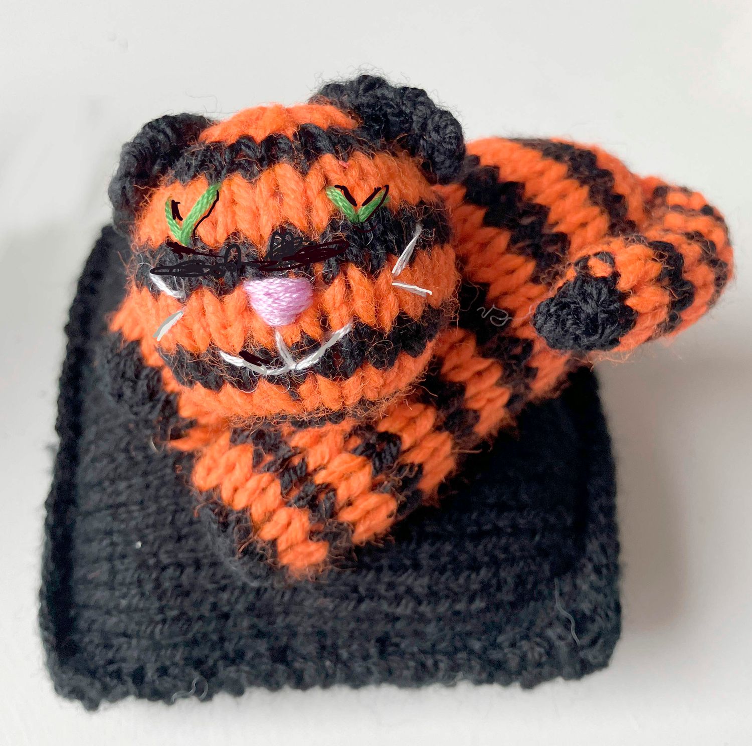 Jen's KNITS BLACK and Orange Striped Cat on BLACK cushion