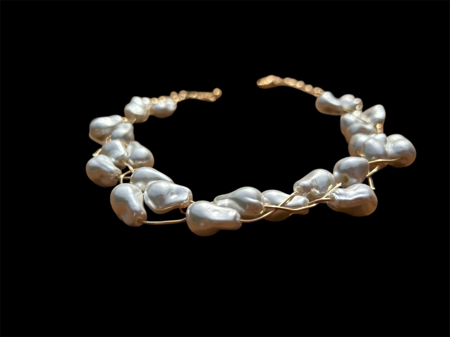 Medium Baroque Pearls braided With Gold Wire.