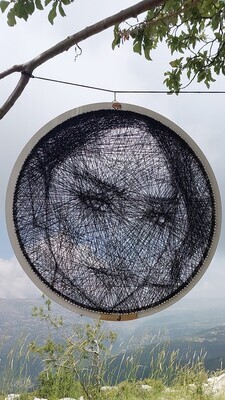 Personalized female thread portrait displayed in a natural landscape
