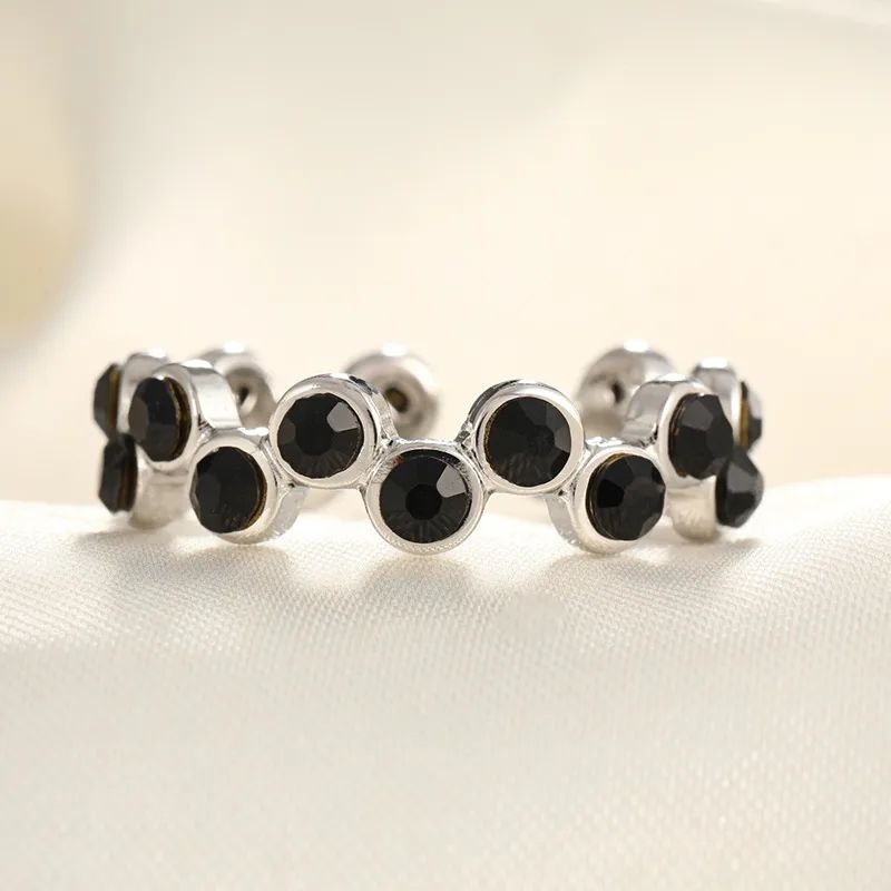Silver ring with black zircons