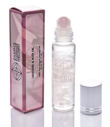 Photo of a Love Roll On Oil bottle, featuring an organic blend for mood elevation and self love. The bottle is clear with a roll-on applicator at the top, filled with a light-colored liquid. The label highlights its use for enhancing positivity and connection.
