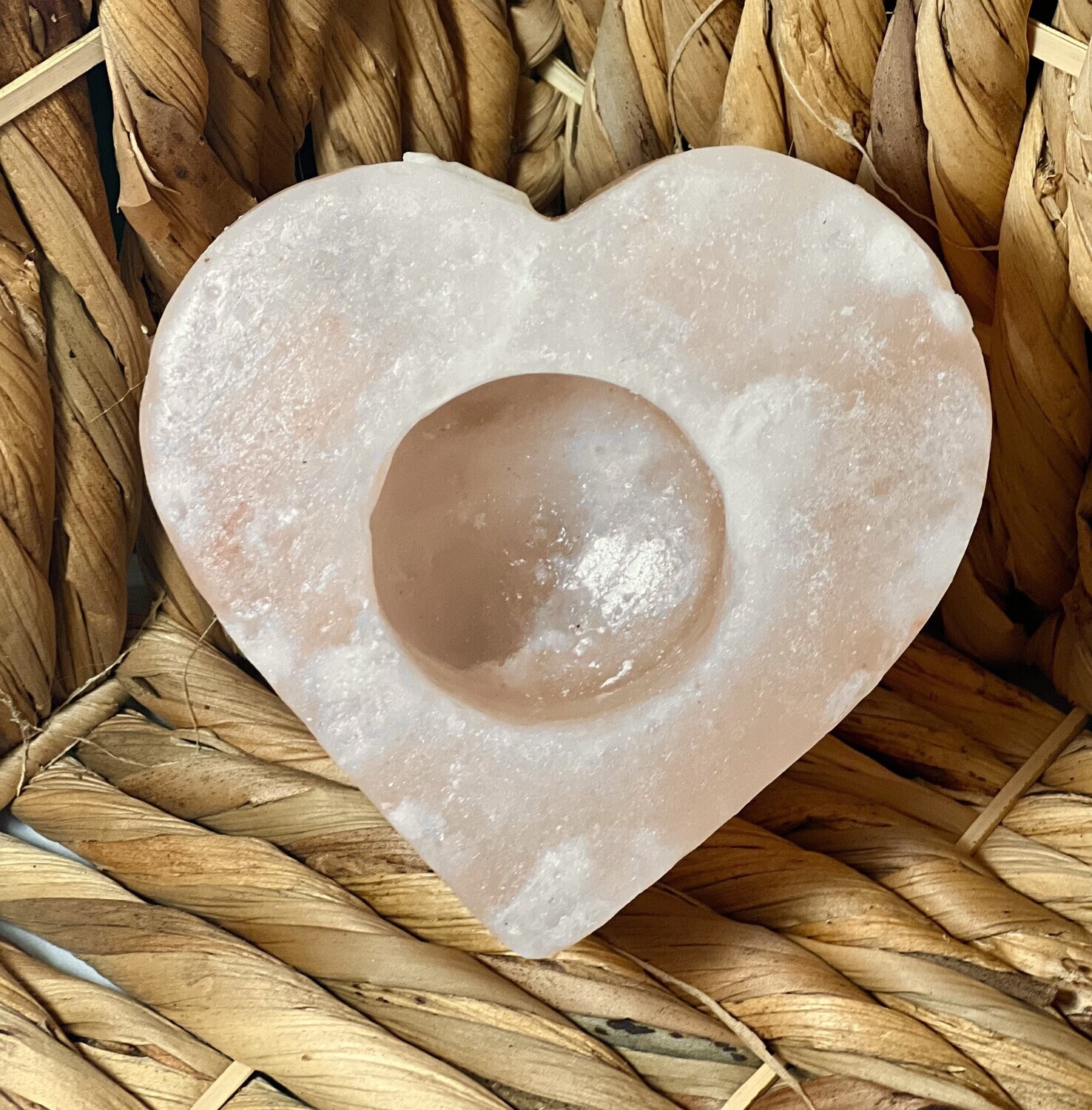Image of a heart-shaped Himalayan salt candle holder that adds a cozy ambiance and natural wellness benefits to your space. Ideal for enhancing home décor and relaxation.