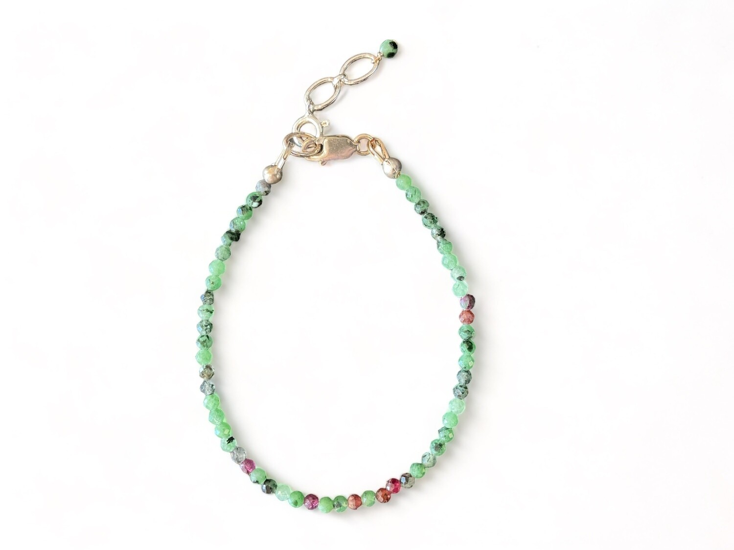 Image of a Ruby Zoisite bracelet with bright micro-faceted red and green beads. The bracelet combines the energizing properties of ruby with the growth benefits of zoisite, perfect for spiritual seekers. It measures 6.5 inches long with a 1 inch sterling silver extender chain.
