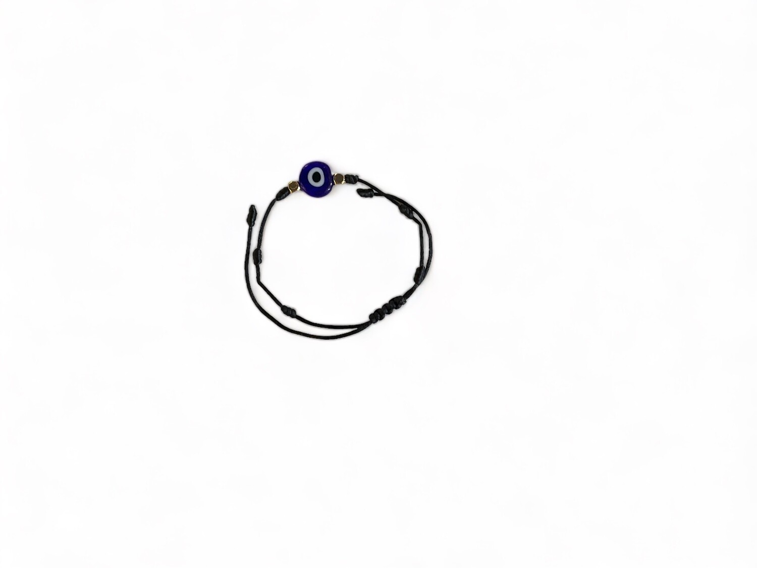 Photo of an adjustable black bracelet featuring a glass evil eye bead. Designed for protection and warding off negative energy, this stylish accessory offers both function and fashion.