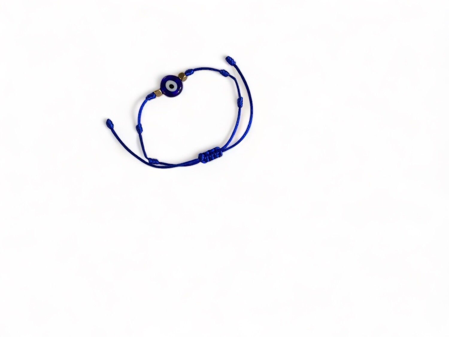 Image of a royal blue bracelet with an adjustable cord and a glass evil eye bead. This simple evil eye jewelry is designed for protection and to deflect negative energy while adding style.