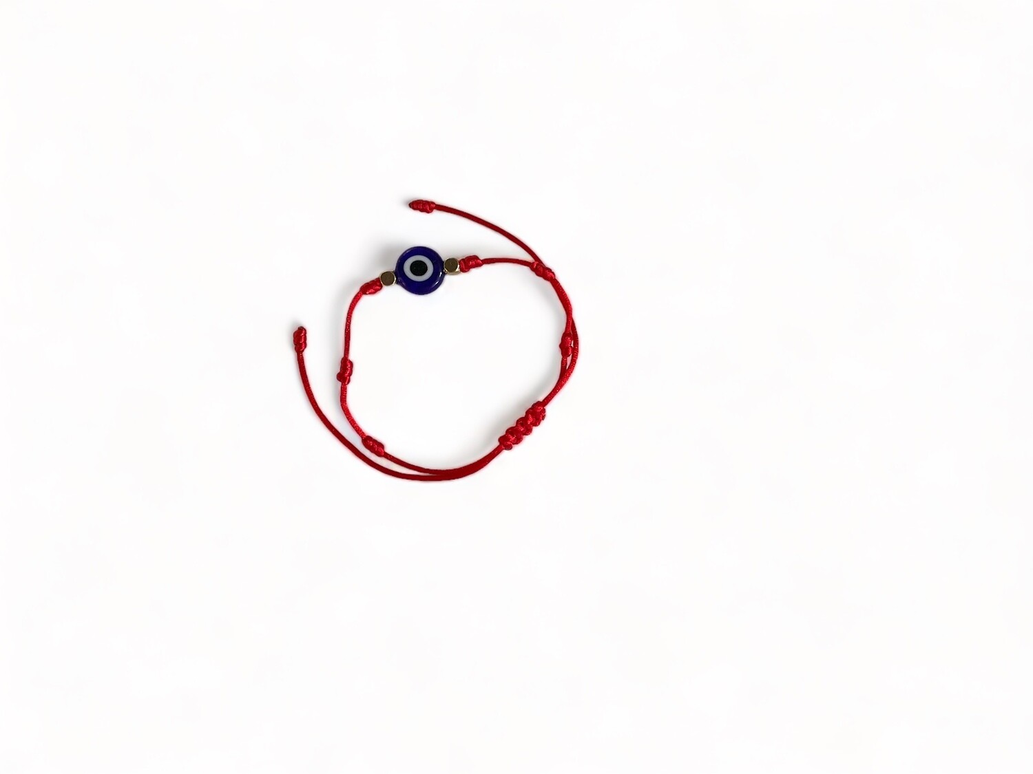 Image of an adjustable red bracelet featuring a glass evil eye bead. Designed to protect and guard against negative energy, making it a thoughtful gift option.