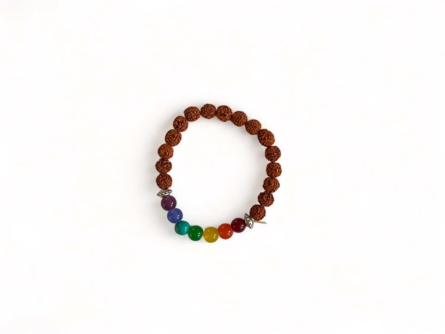 Image of a Seven Chakra Rudraksha stretchy bracelet featuring rudraksha seeds and seven colorful chakra stones. Designed to aid energy alignment and spiritual growth.
