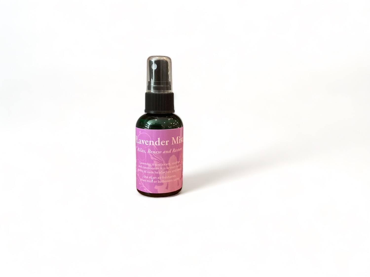 Photo of a two ounce bottle of Lavender Mist Spray. The bottle features a label with the text &#39;Lavender Mist Spray&#39; . The label highlights its use for relaxing and renewing as an air freshener, linen spray, or bathroom mist. It is crafted with essential oils and sacred waters. The design emphasizes its calming and versatile properties.