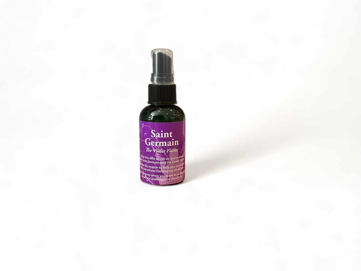 Saint Germain Spray two ounce bottle. - A spiritual mist designed for positive transformation. The spray is housed in a clear 2 oz bottle with a label indicating &#39;Saint Germain Spray.&#39; The label features text describing the product&#39;s use for connecting with St. Germain and the Violet Flame to help transform and transmute challenges. The formulation includes essential oils and sacred waters. The bottle&#39;s design reflects a sense of spiritual and mystical purpose.