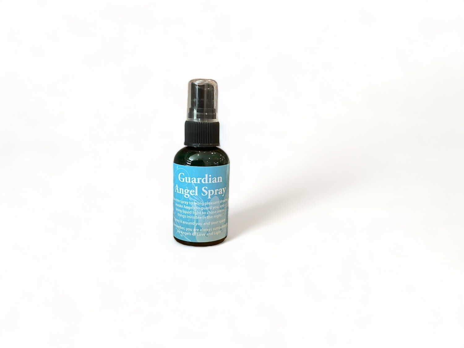 Photo of a two ounce bottle of Guardian Angel Spray. The bottle has a label reading &#39;Guardian Angel Spray&#39;. The label highlights its purpose as a spiritual mist designed to invite angelic presence, offering protection and fostering pleasant dreams. The design emphasizes the sense of love and light that the spray is intended to provide. 