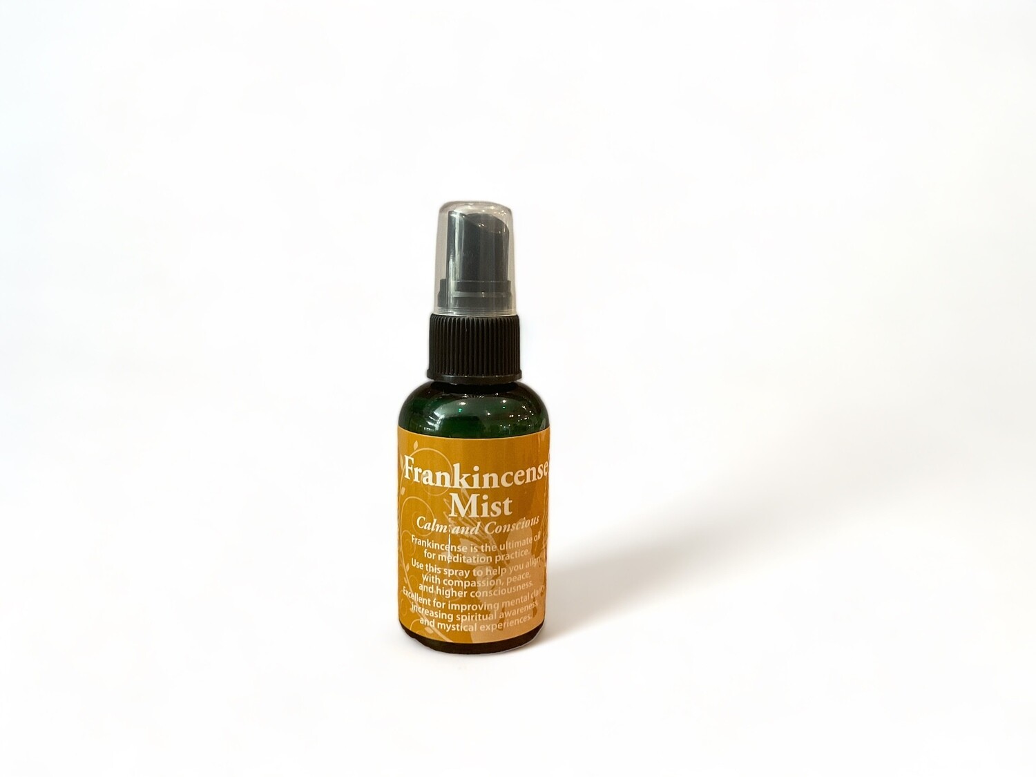Image of a two ounce bottle of Frankincense Mist Spray. The bottle features a label with the text &#39;Frankincense Mist Spray&#39; and &#39;Calm.&#39; The label emphasizes its use for enhancing calm and conscious energy, with a focus on meditation and spiritual alignment. It contains premium essential oils and sacred waters. 