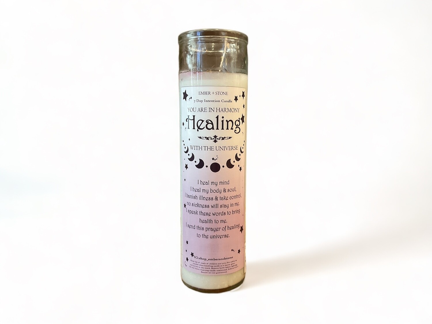 Image of a chic skinny glass jar containing a healing intention candle from The Crystal Shrine. Ideal for creating a tranquil atmosphere in any space.