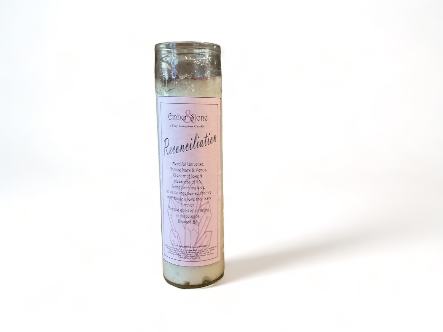 Image of a sleek skinny glass jar containing the reconciliation intention candle from our metaphysical shop in Los Angeles. Ideal for healing and mending relationships while fostering peace.