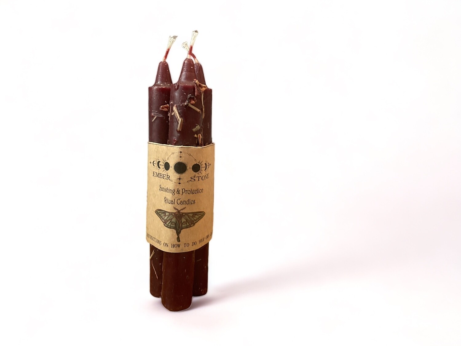 Image of the Banishing &amp; Protection Ritual Candle Bundle featuring three pre-dressed dark taper candles, designed for rituals with straightforward instructions included.