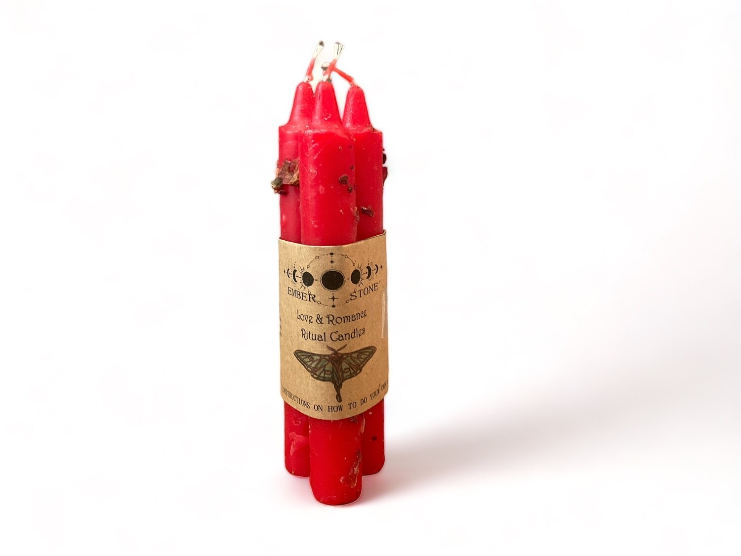 Image of three pre-dressed red taper candles in a bundle for love and romance. Comes with instructions to help enhance your romantic rituals.