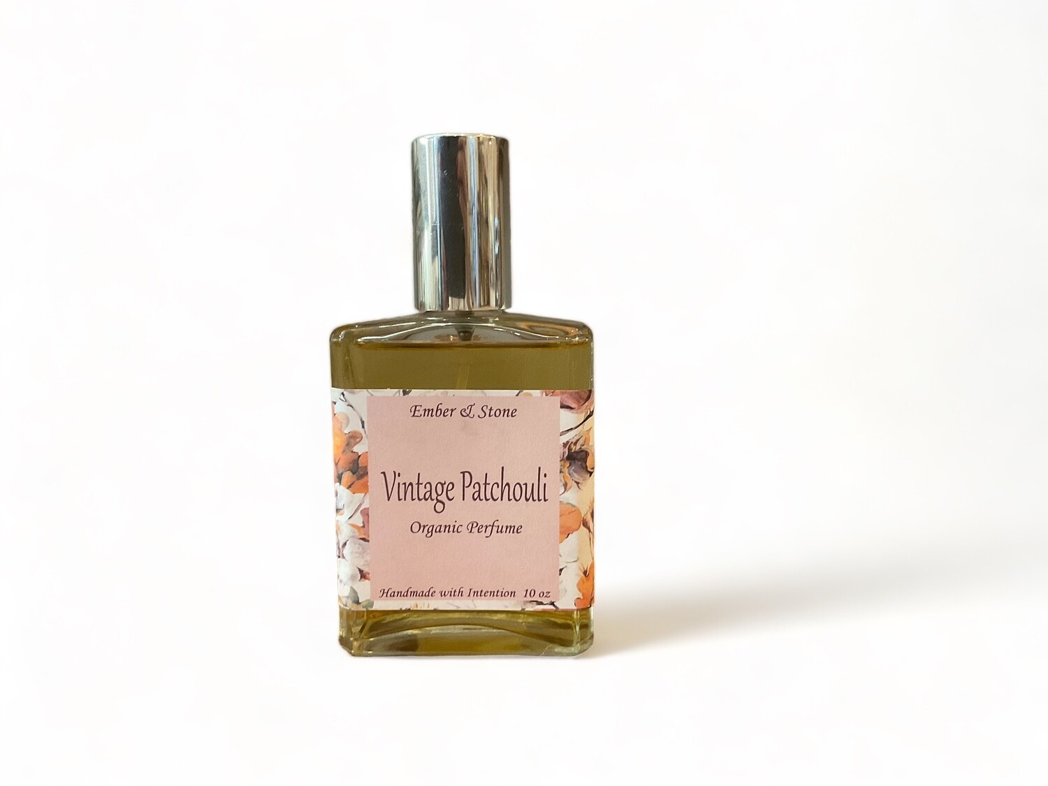 Photo of a Vintage Patchouli Organic Perfume bottle. The perfume has a deep, spicy aroma and is designed for use as a body perfume or to scent linens and spaces. The bottle is topped with a spray cap for easy application.