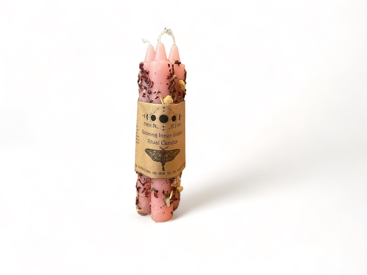 Photo of three pink taper candles in a bundle with an instruction guide for Goddess Rituals. Pre-dressed and ready for use to help reclaim your inner goddess.