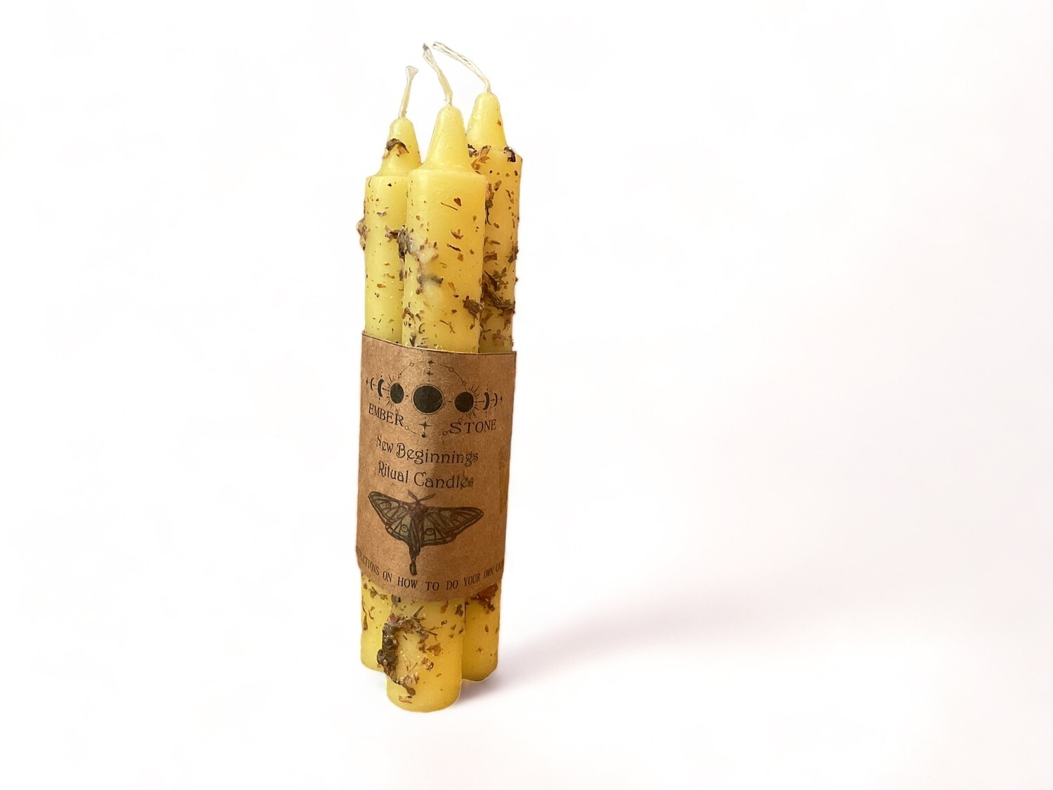 Photo of three pre-dressed yellow taper candles in a bundle for new beginnings. Includes instructions to guide your fresh start rituals.