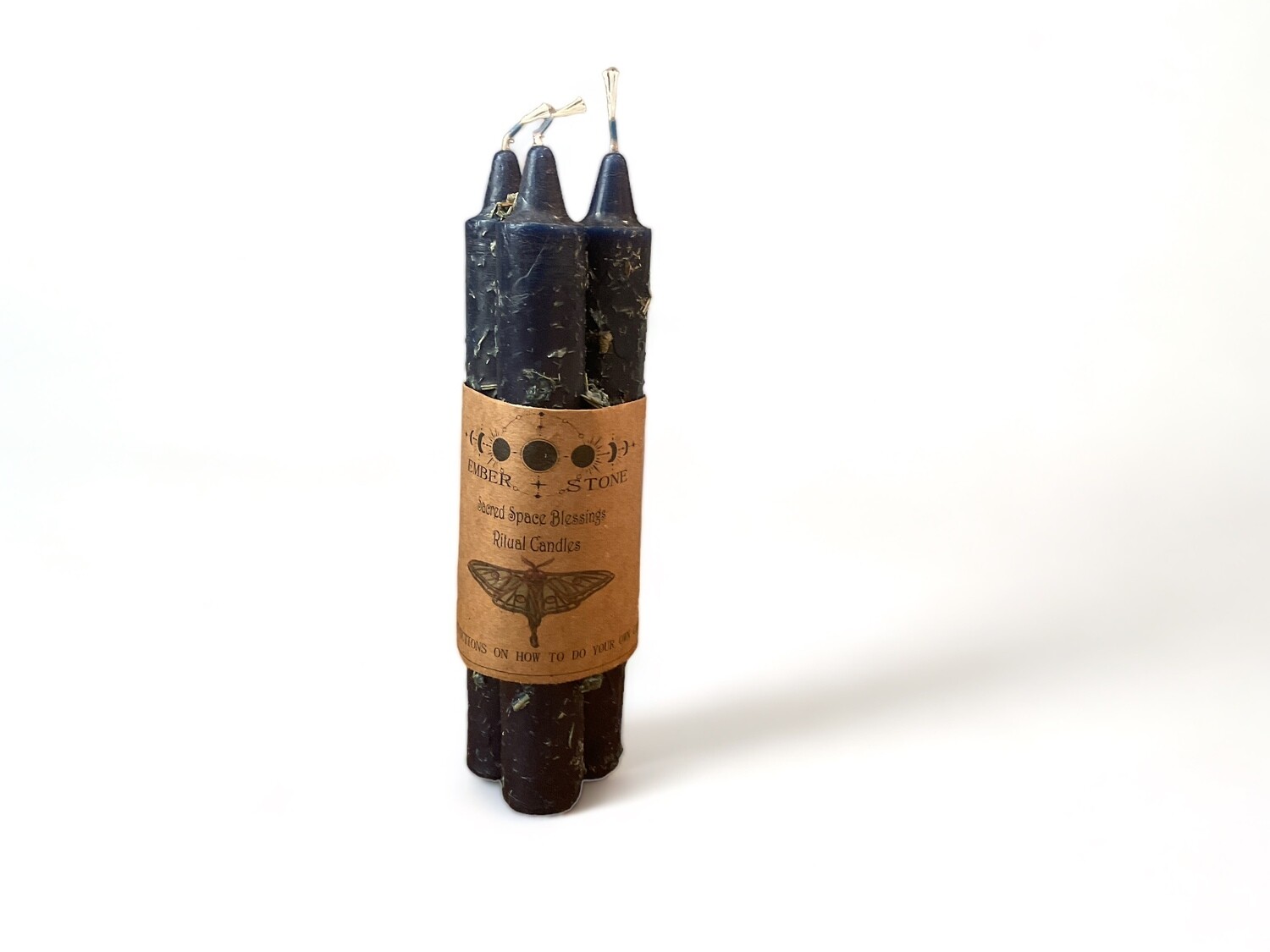 Image of three pre-dressed dark blue taper candles in a bundle for sacred space blessings. Includes instructions to enhance your transformation rituals.