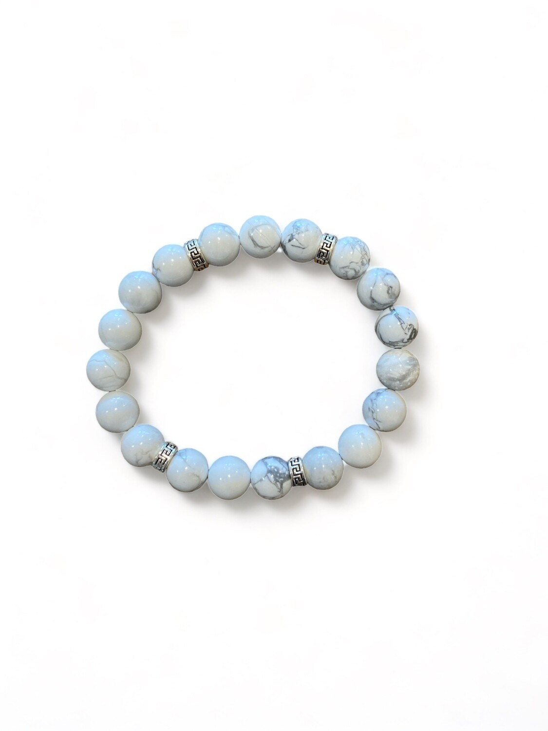 This stylish 10mm howlite gemstone bead bracelet features smooth, white beads with gray veining. It is designed to promote patience, calm, and focus, making it ideal for daily tranquility and aiding in improving sleep.