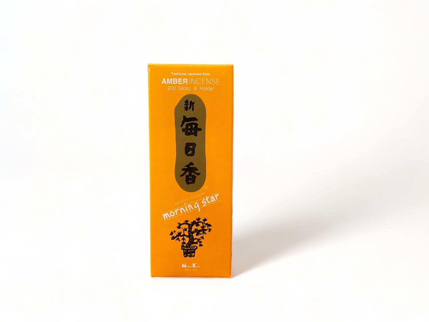 Photo of an orange box of Amber Morning Star Incense, containing 200 sticks / 200 grams. Each stick is Japanese style, made from compressed herbs and resins. The incense has a clean burn, the box also includes a small burner. The sticks are neatly arranged inside the box, which features labeling and a compact design.