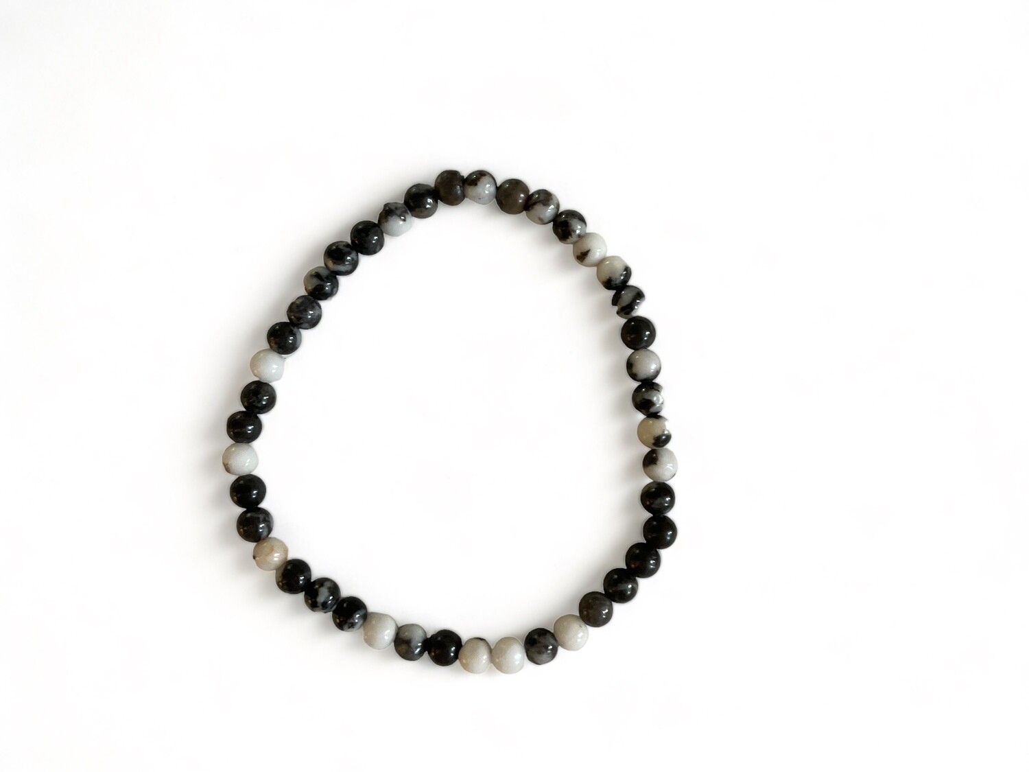 Detailed photo of the Zebra Stone Power Minis Bracelet with striking black and white beads. Designed to promote balance, grounding, and clarity while enhancing strength and harmony.