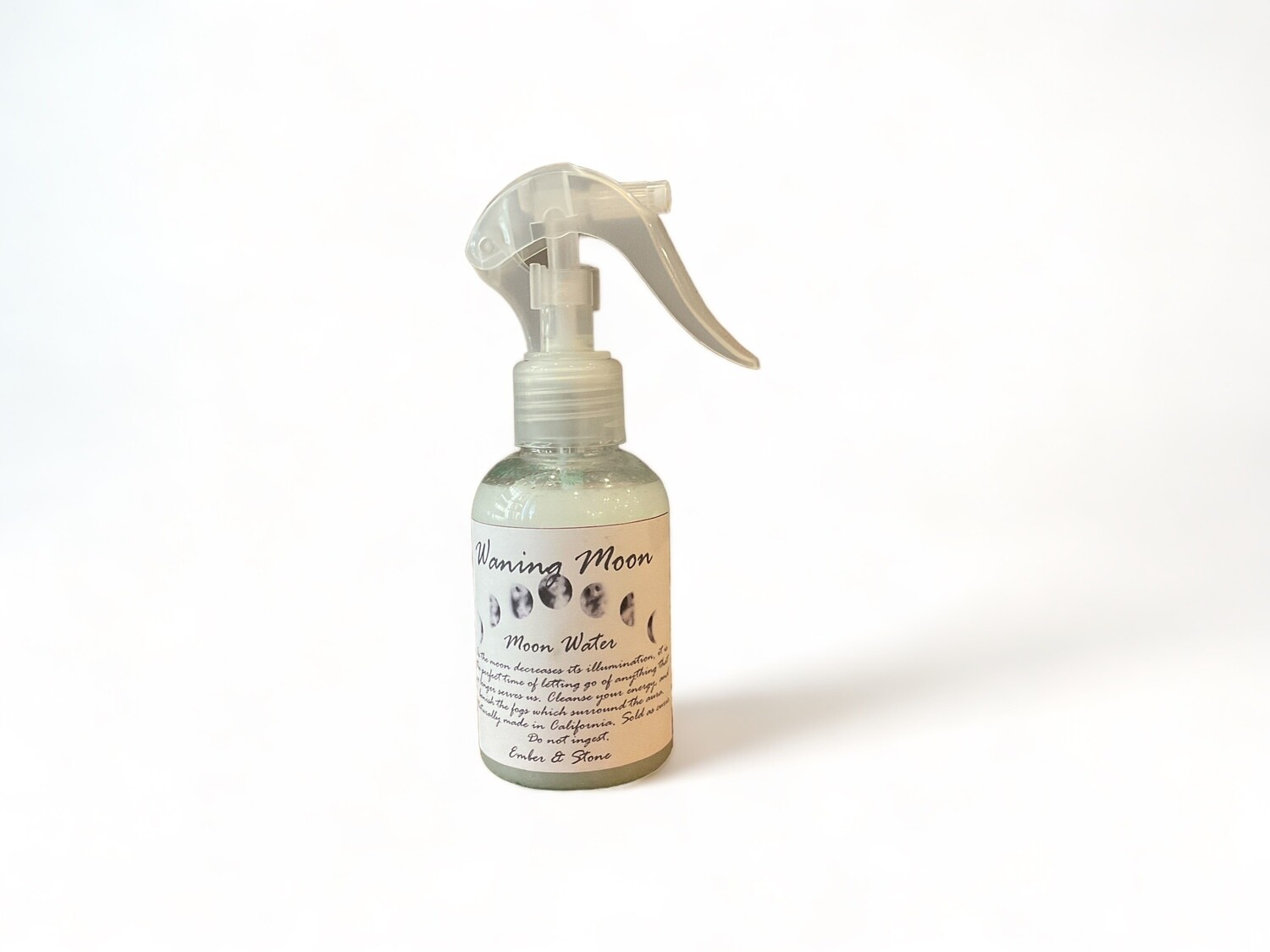 Waning Moon Spray two ounce - This spray is designed for release and renewal during the waning moon phase. The bottle features a label indicating its use for cleansing energy, ideal for letting go of what no longer serves you. The design includes a serene moon-themed graphic, emphasizing its spiritual and cleansing properties. 