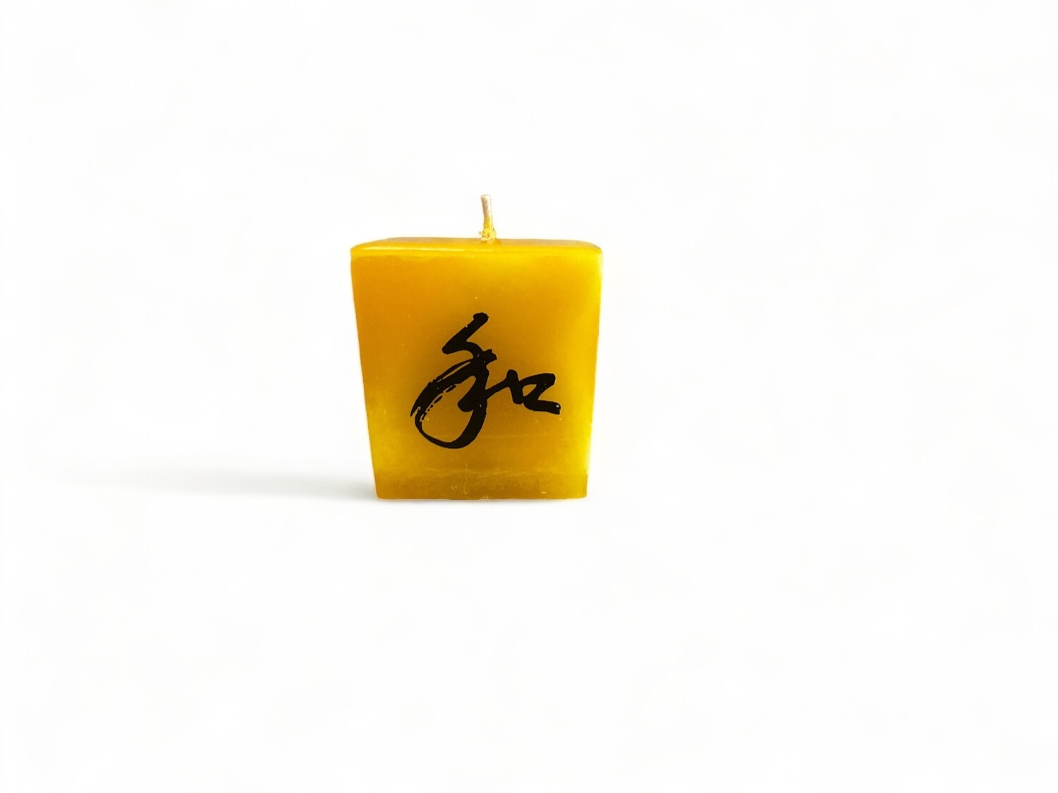 Image of the Harmony cube votive candle featuring Vanilla, Ginger &amp; Frankincense fragrance. Crafted from food-grade ingredients and vegetable waxes, with a lead-free wick and up to 20 hours of burn time.