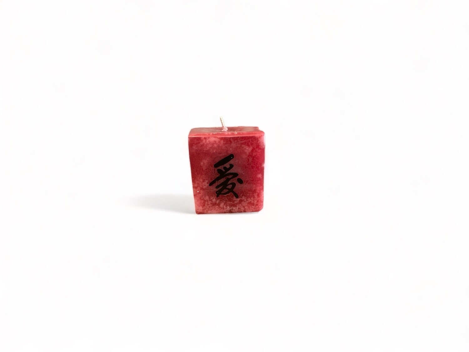 Image of the Love cube votive candle infused with Pomegranate &amp; Passion Fruit fragrance. Crafted from food-grade ingredients and vegetable waxes, with a lead-free wick providing up to 20 hours of burn time.