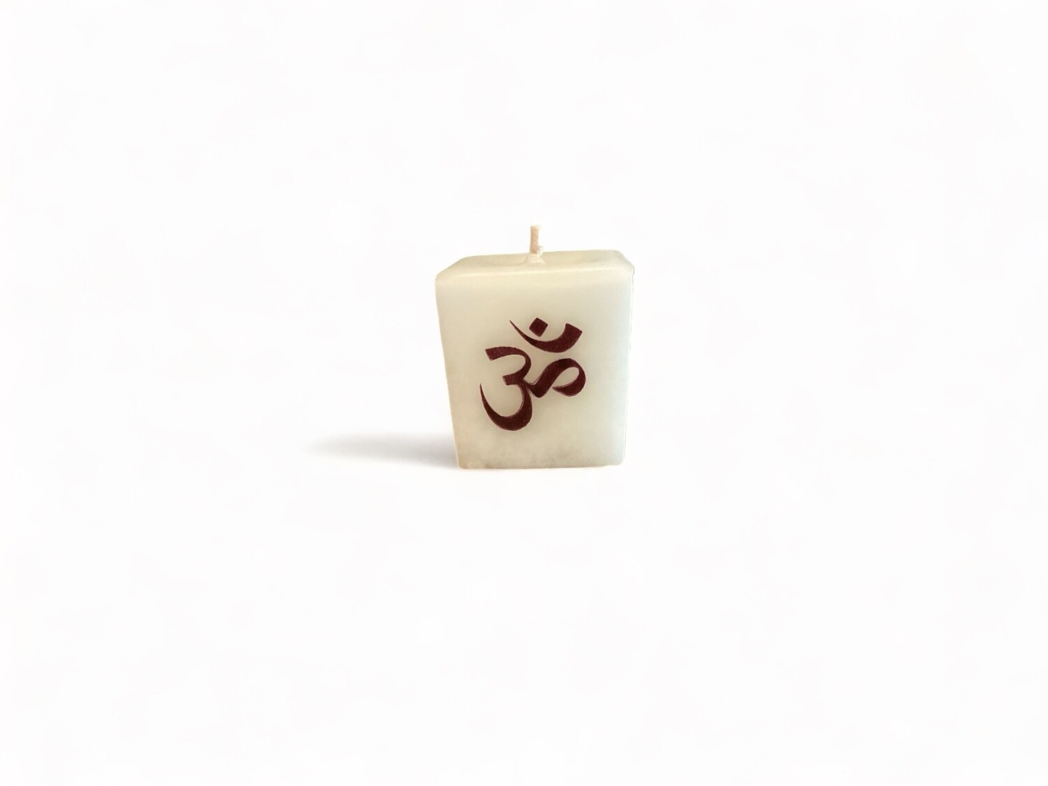 Image of the Om cube votive candle, scented with Gardenia fragrance. Made from food-grade ingredients and vegetable waxes, featuring a lead-free wick and offering up to 20 hours of burn time.