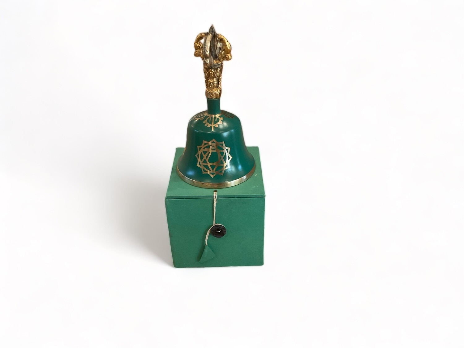 Image of a Green Heart Chakra Tibetan Bell, 5.5 inches, with a striker. The bell features a vibrant green color and intricate designs . The bell’s smooth, polished surface has a deep, resonant quality that creates a rich, harmonious sound. The striker, used for striking the bell, complements its design. This set is designed for clearing space and harmonizing the heart chakra, ideal for enhancing love and compassion.